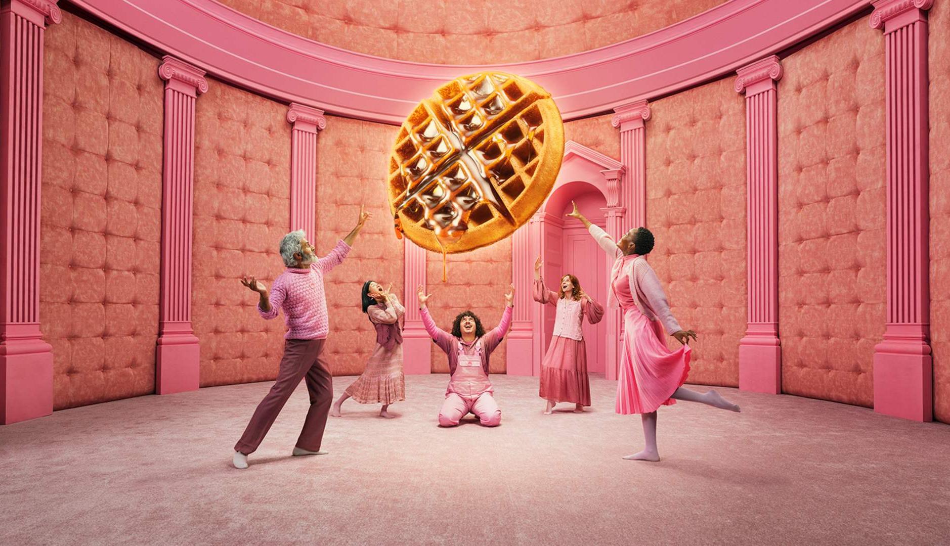 Grupo de personas vestidas de rosa adorando un gofre