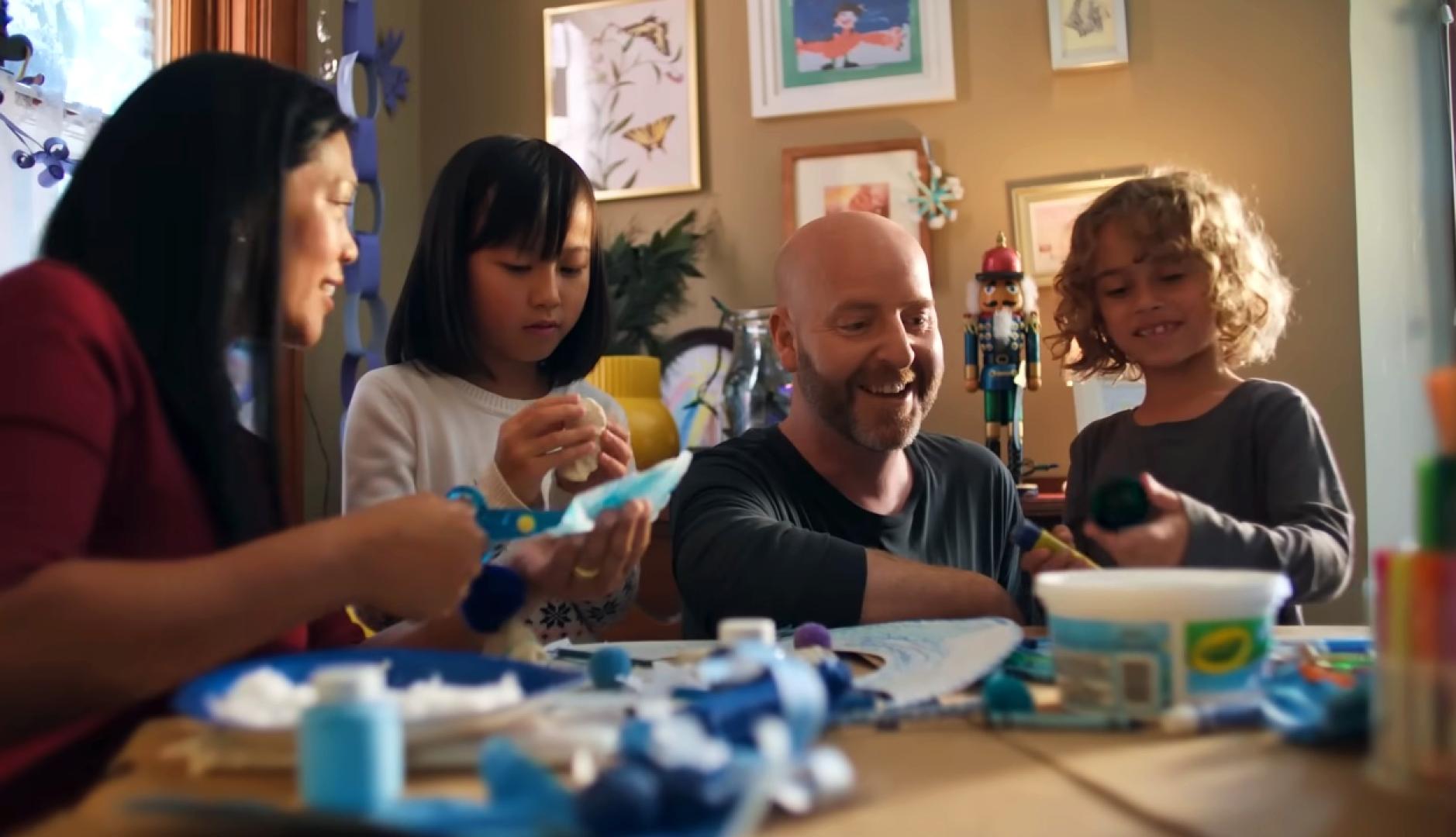 La familia del anuncio haciendo manualidades navideñas en colores azules