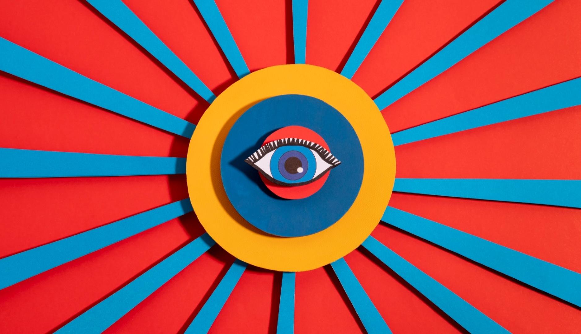 Un collage de colores con un ojo en el centro y líneas rojas y azules hacia los extremos